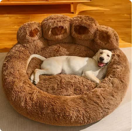 Dog lying on a fluffy brown pet bed with a wooden floor background